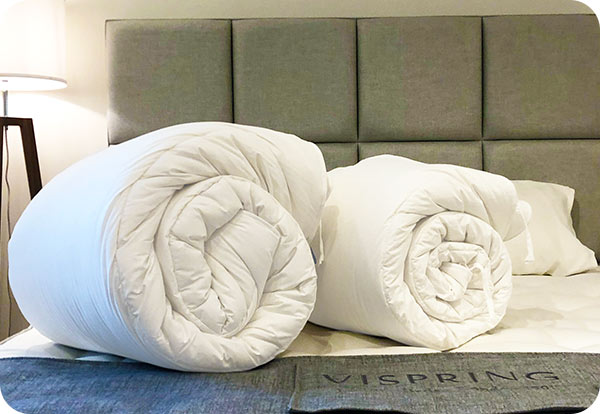 Luxurious bedding collection, featuring handcrafted duvets with high thread counts, promising a great night's sleep.