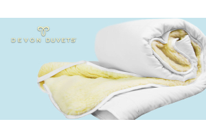 Devon Duvets reversible mattress topper product shot with logo.
