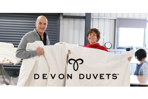 Dick and Pauline, founders of Devon Duvets, proudly presenting their handcrafted British wool duvet.