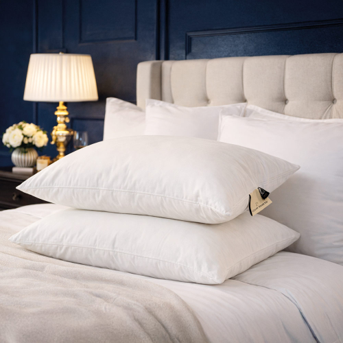 Side profile of adjustable wool pillow showing supportive loft and smooth natural cotton casing