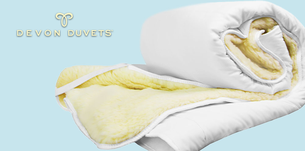 Devon Duvets reversible mattress topper product shot with logo.