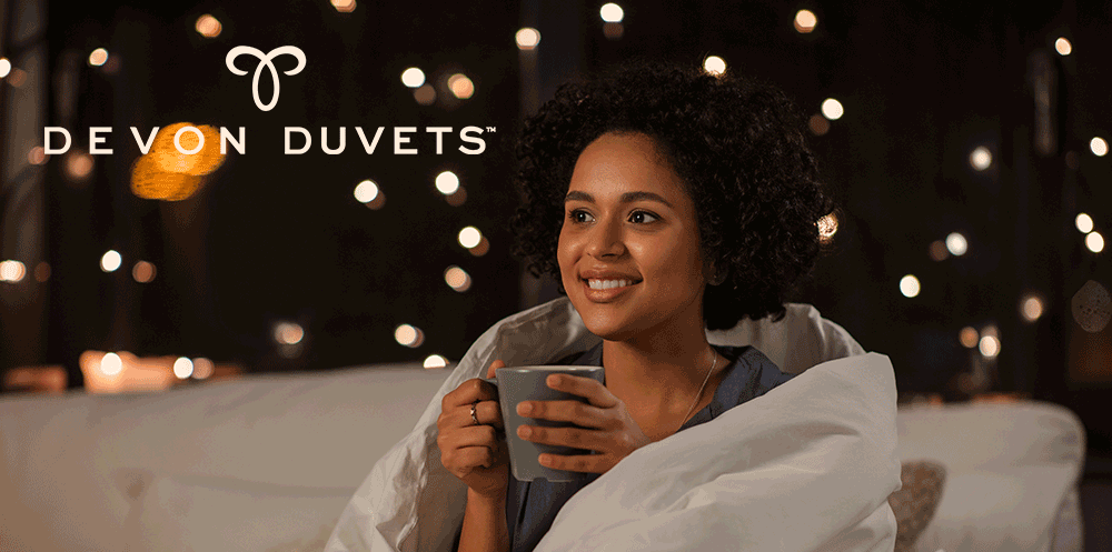Woman snuggled under luxurious thick wool duvet
