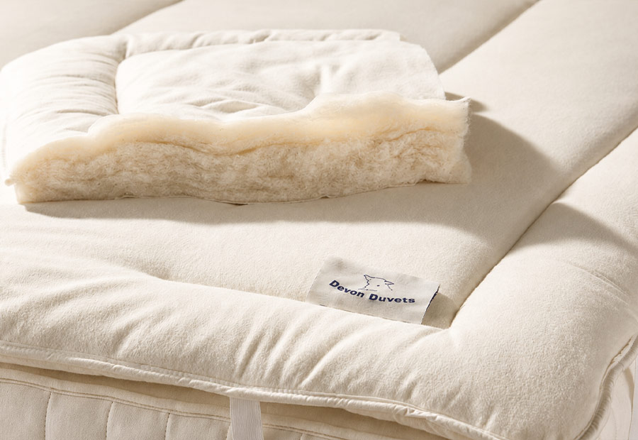Soft brushed cotton outer fabric on a Devon Duvets wool mattress topper.