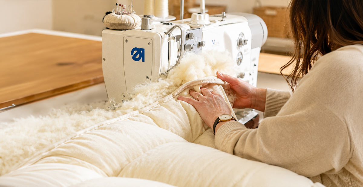 Cotton casing being carefully sewn in the Devon Duvets workshop.