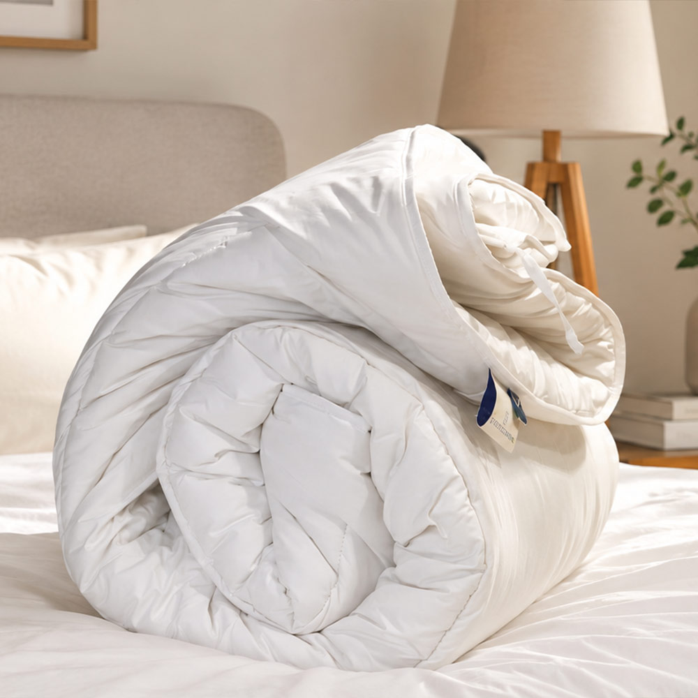 Finished cotton casing and stitching on handcrafted Devon Duvets bedding.