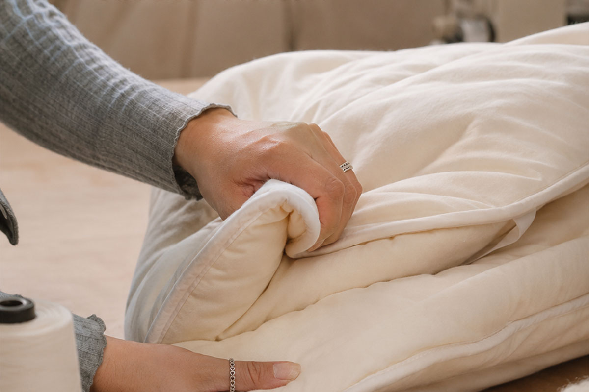 A welcoming guest bed prepared with natural bedding and a thoughtful note