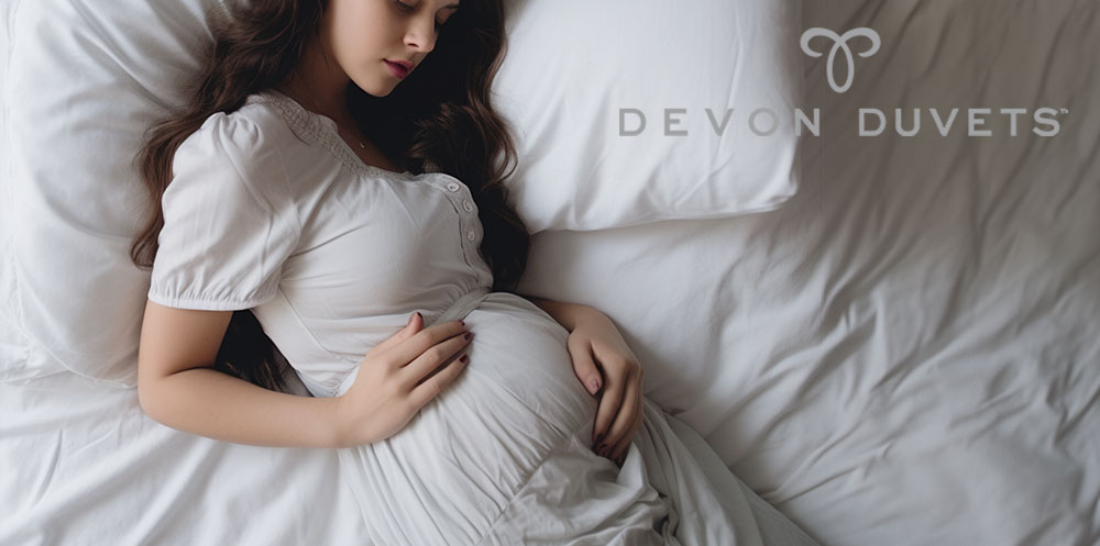 Lady in bed gently holding her belly, depicting comfort and care during pregnancy.
