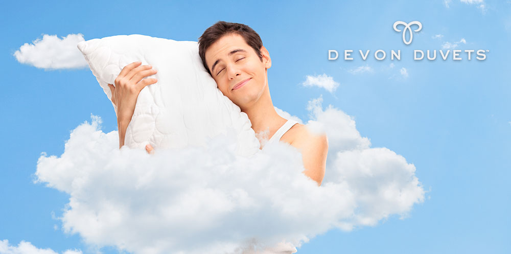 Man floating in the sky, embracing a pillow, symbolizing comfort and relaxation during travel.