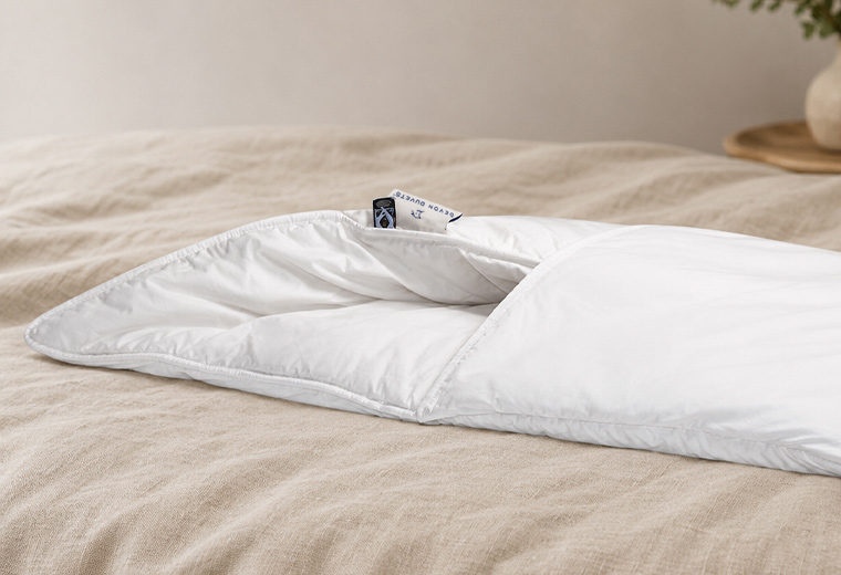 2 Fold Wool Pillow styled on a natural bed showing a lower pillow profile.