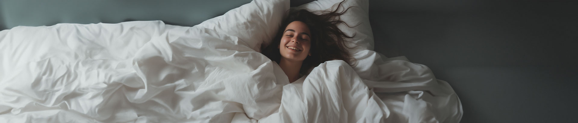 Satisfied customer relishing the comfort of a Devon Duvets wool duvet in a cozy bedroom.