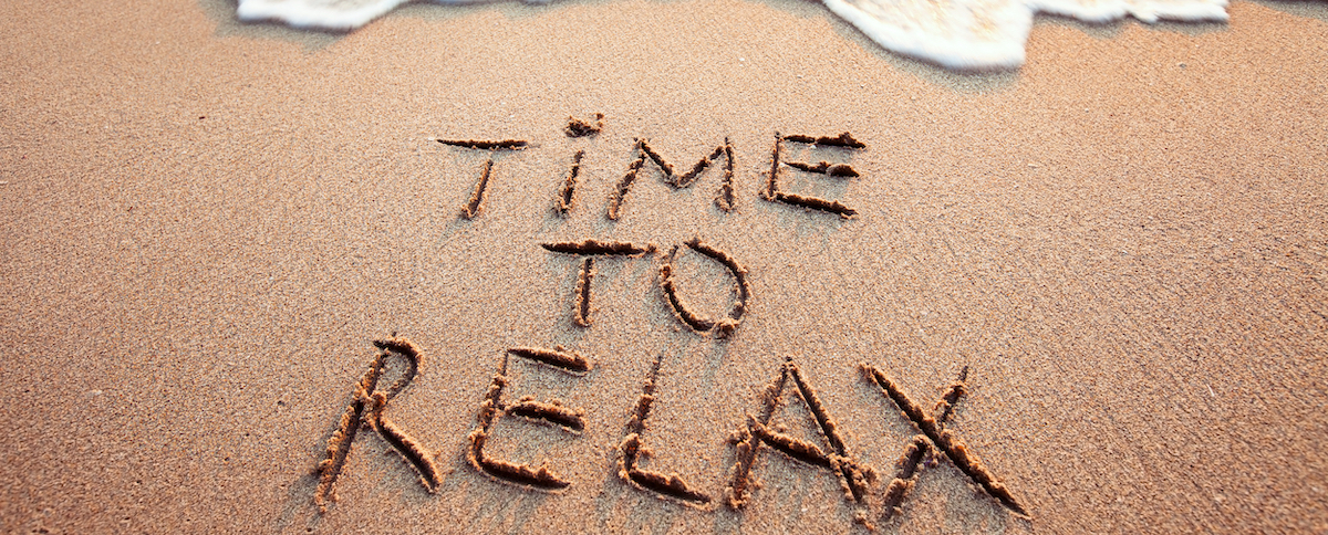 Soothing image of sandy beach with the calming message 'Time to Relax' inscribed, evoking a sense of peace and leisure.