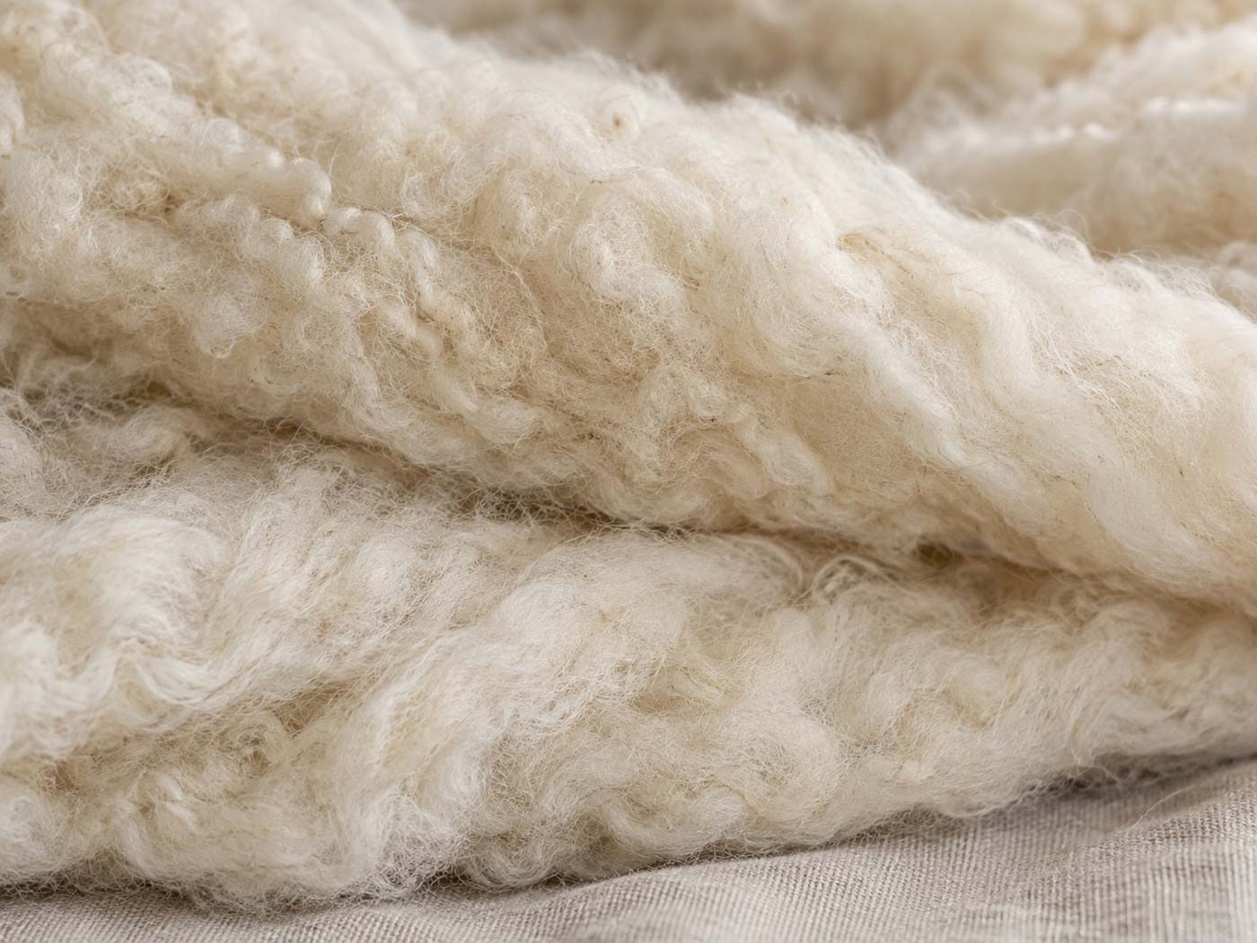 Close-up of softly layered British wool fibres showing their natural texture and loft