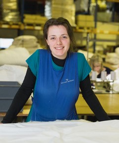 Artisan seamstresses crafting bespoke wool duvets at Devon Duvets workshop.