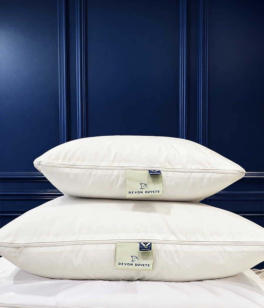 Three Fold wool pillow on an ivory bed.