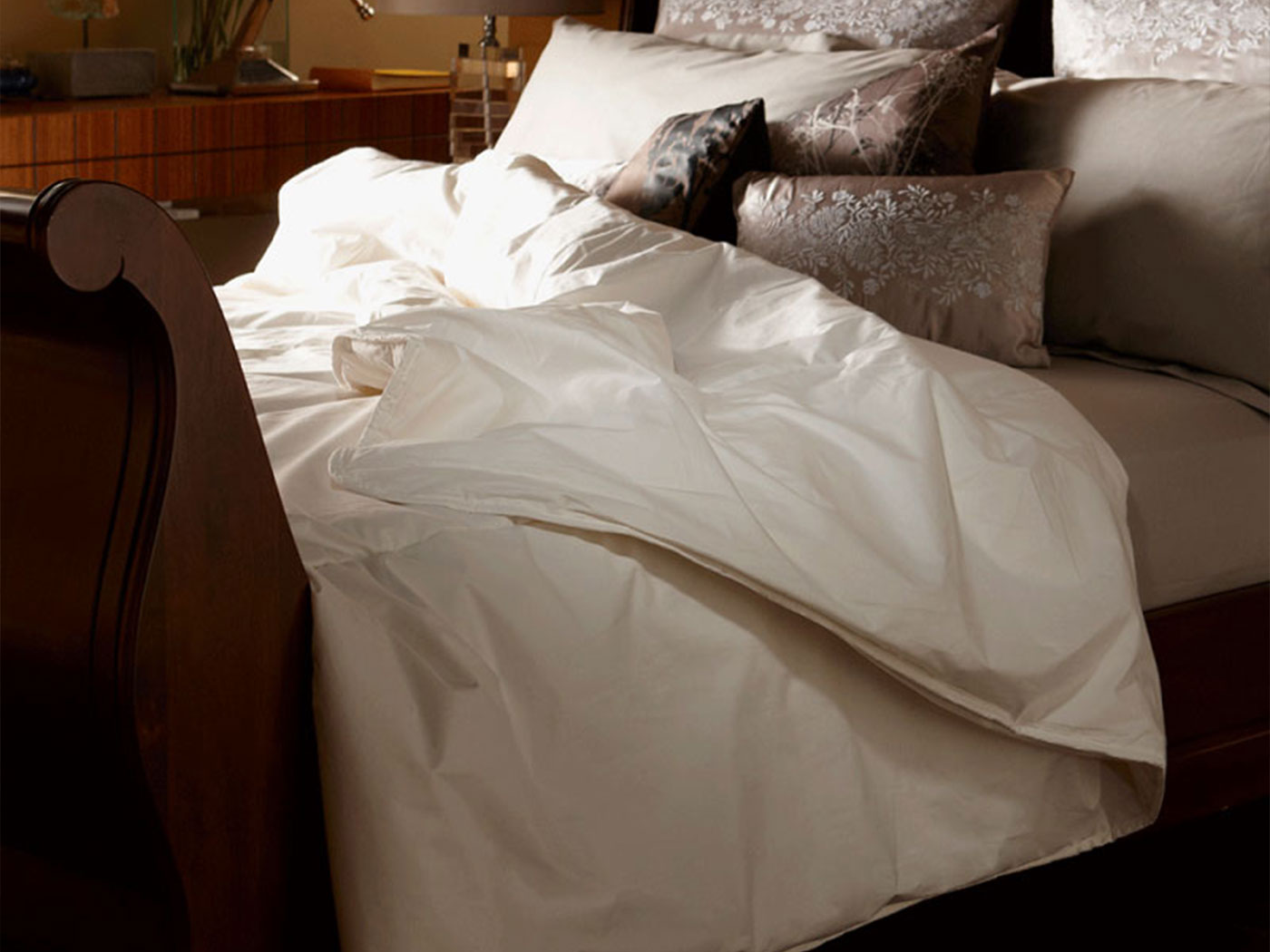 Prepared ivory wool layers beside cream woven cotton and brushed cotton samples