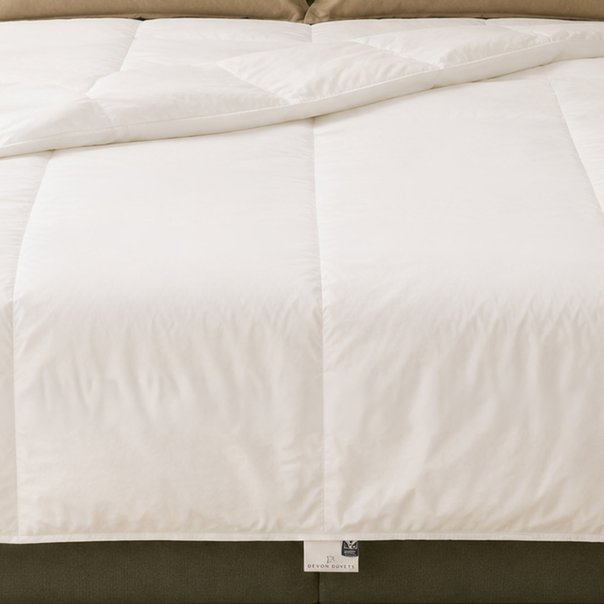 Lightweight British wool duvet handcrafted in Devon and shown on a bed