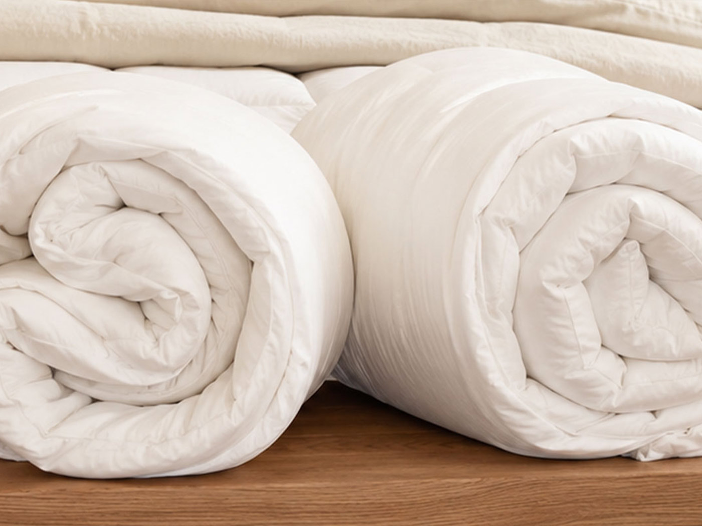 A softly draped cotton-covered wool duvet showing its natural loft and minimal stitching